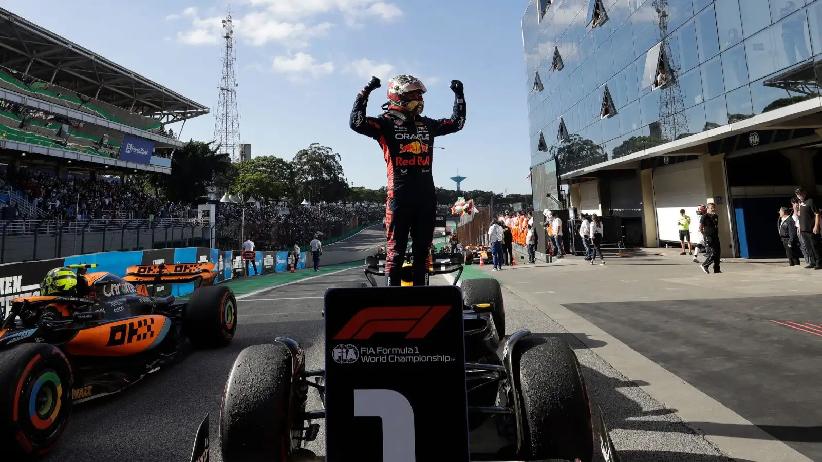 Red Bull driver Max Verstappen stands on his RB19 was he celebrates yet another race win.