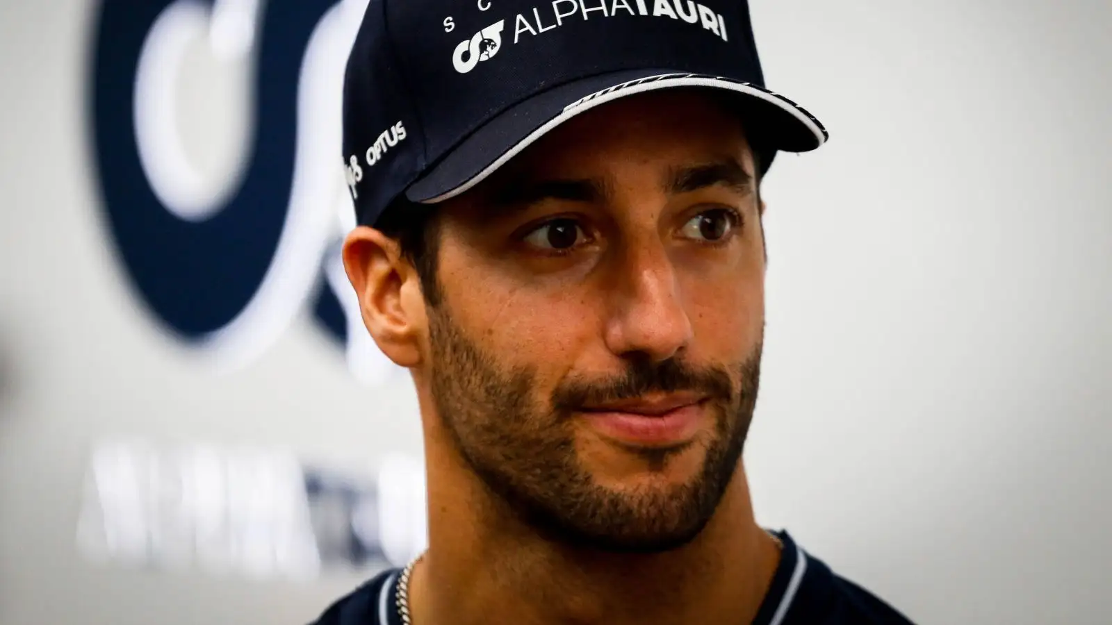 AlphaTauri driver Daniel Ricciardo faces the media.