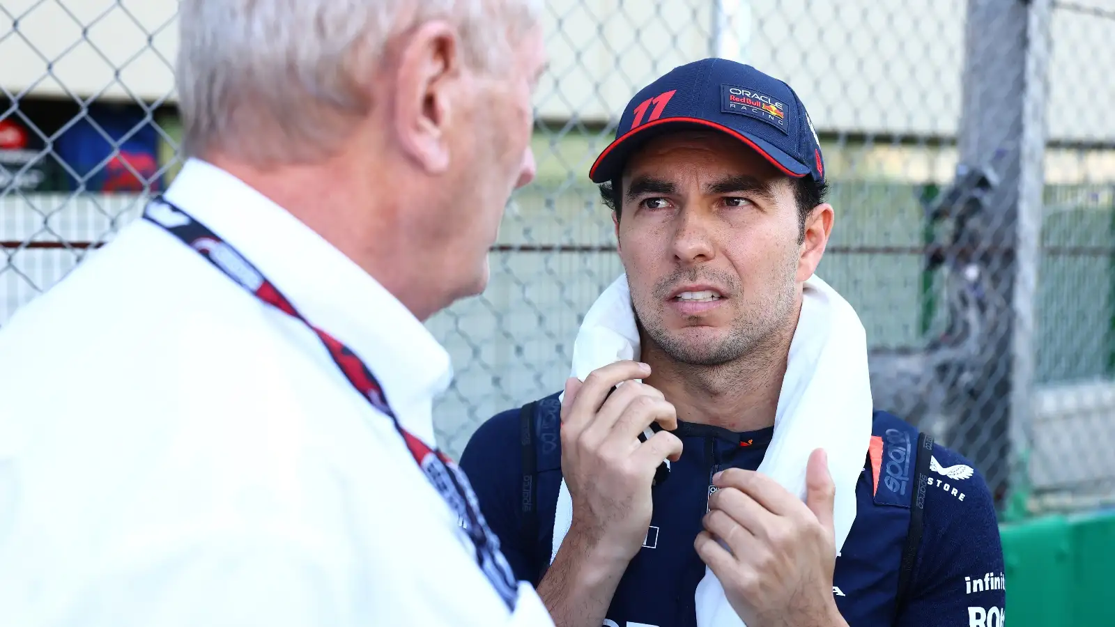 Sergio Perez grimaces at Red Bull senior advisor Helmut Marko.