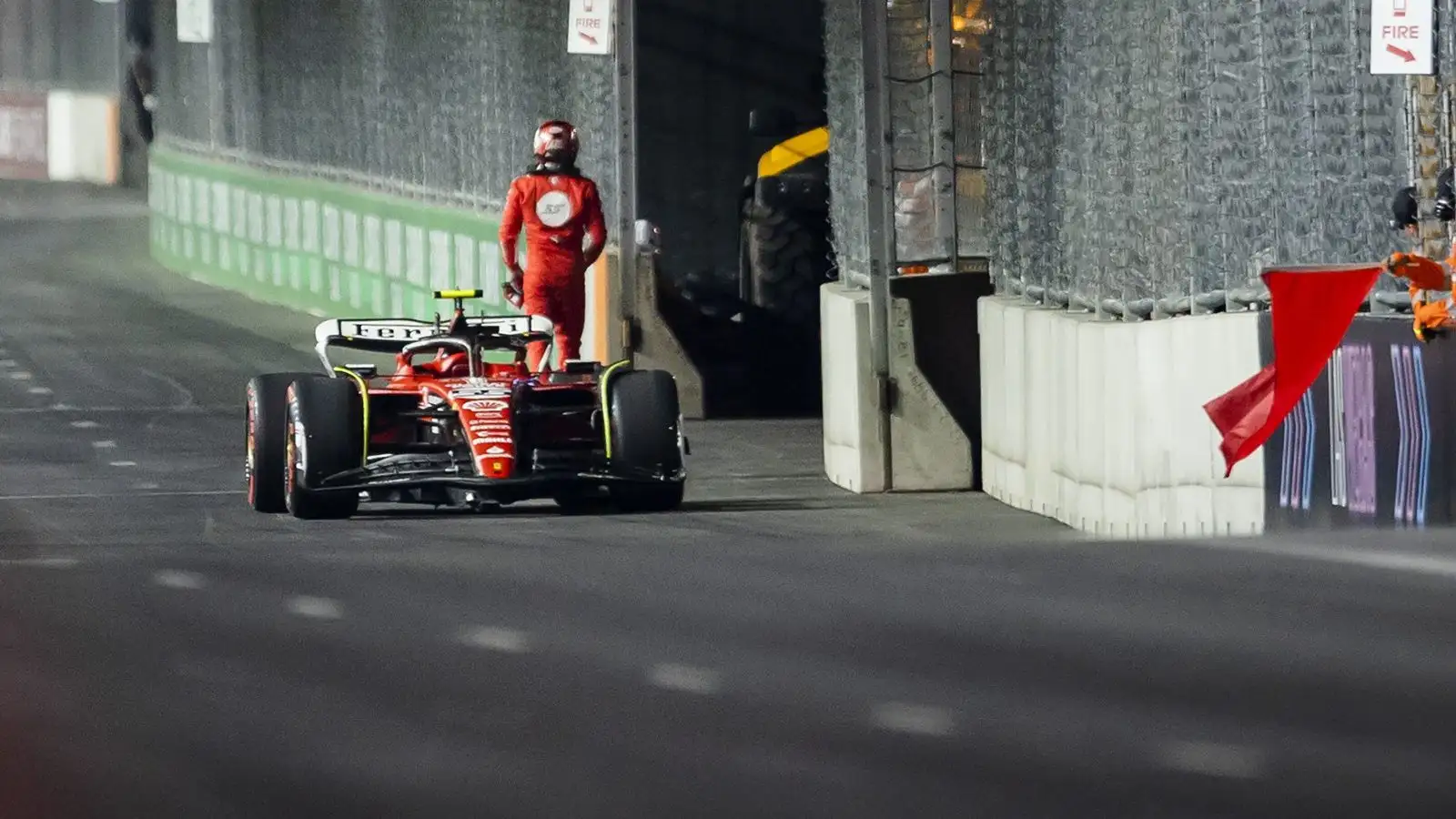 Spanish driver Carlos Sainz walks away from his stricken Ferrari SF-23.