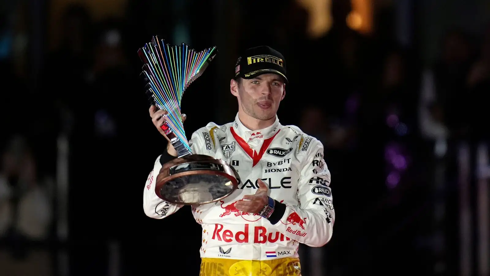 Max Verstappen holding the winners trophy.