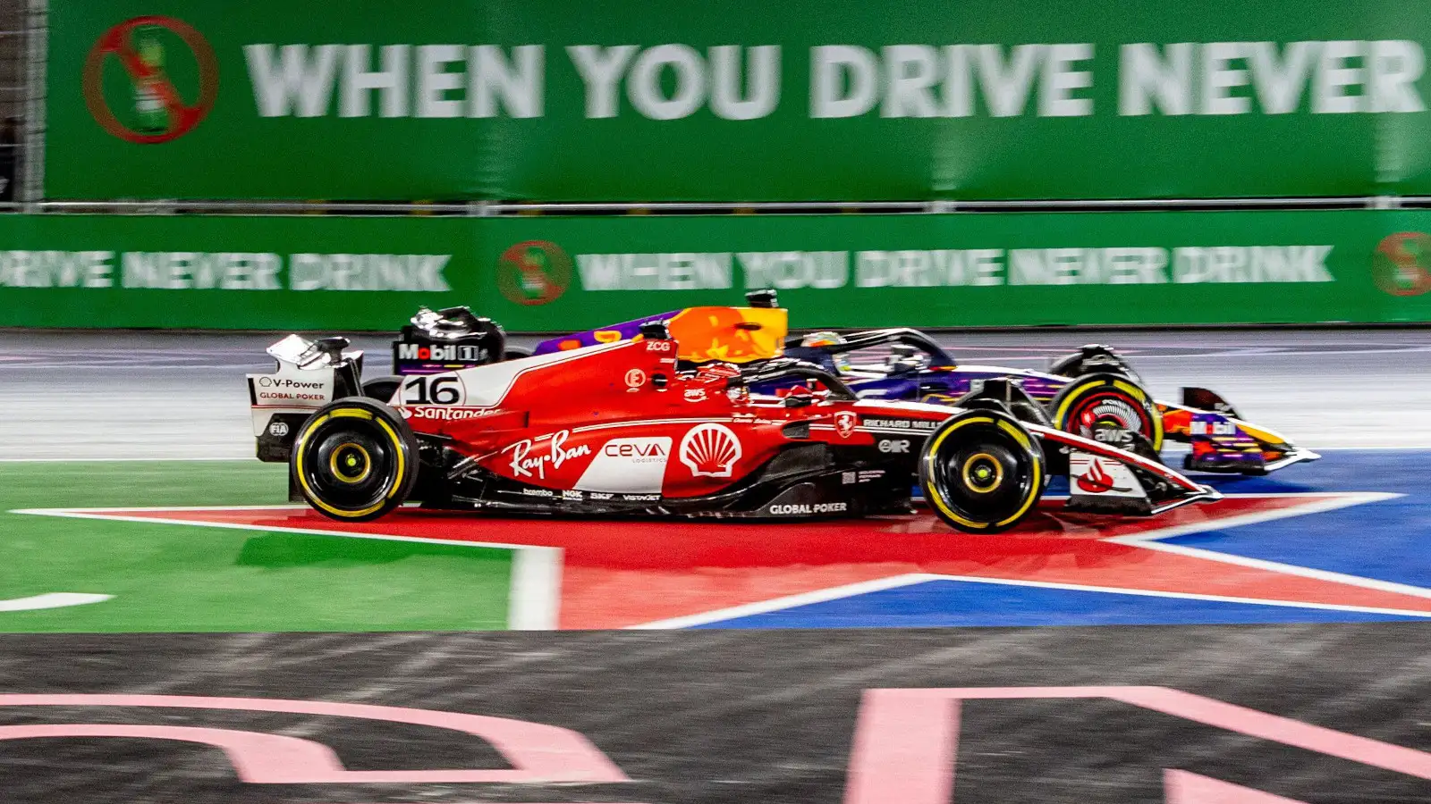 Eventual race winner Max Verstappen pushes Charles Leclerc wide as they fight for the lead.