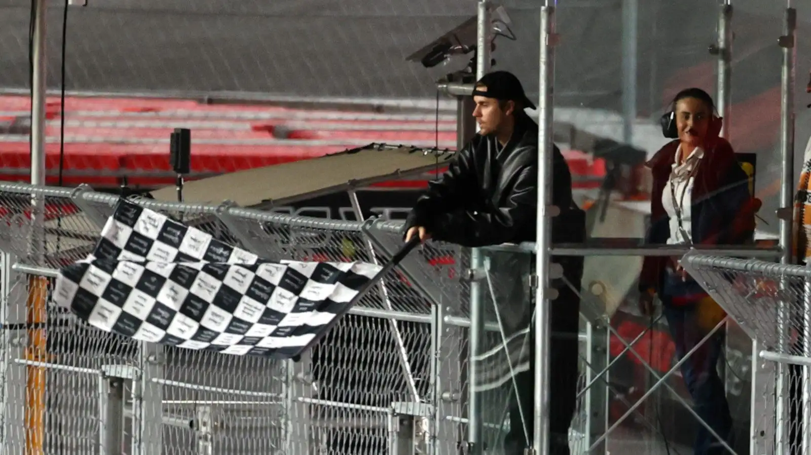 Singer Justin Bieber waves the chequered flag at the end of the race.