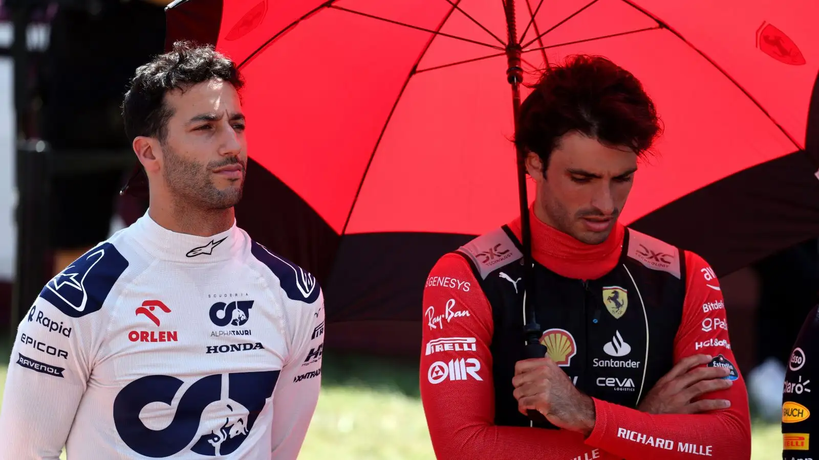 Daniel Ricciardo and Carlos Sainz standing for the national anthem.