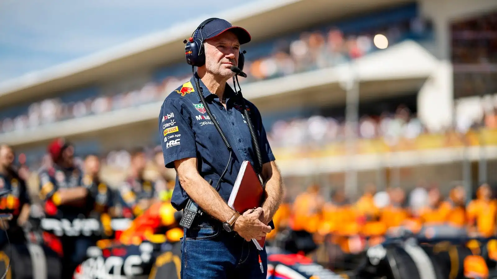 Adrian Newey with his notebook on the grid.
