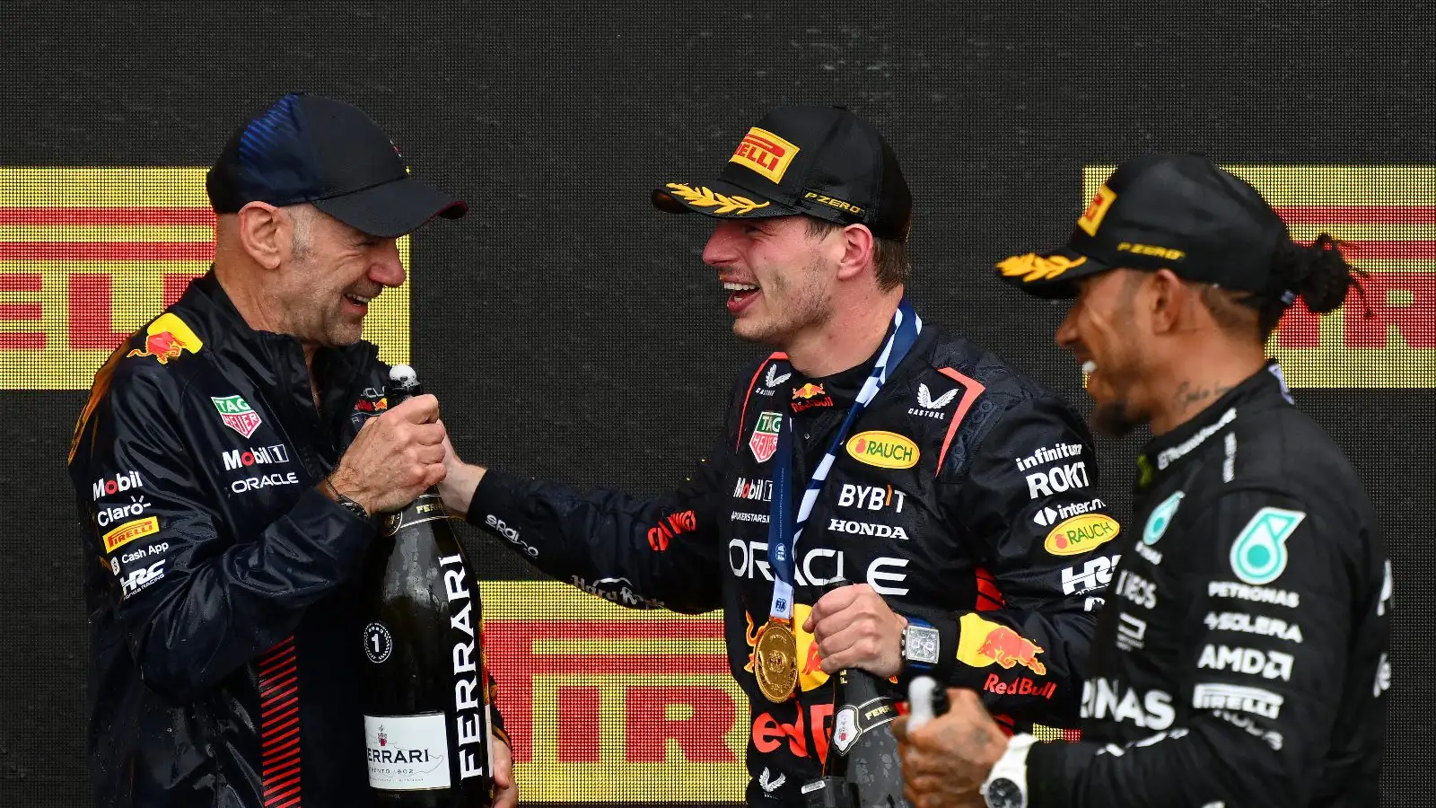 Adrian Newey, Max Verstappen and Lewis Hamilton on the podium.