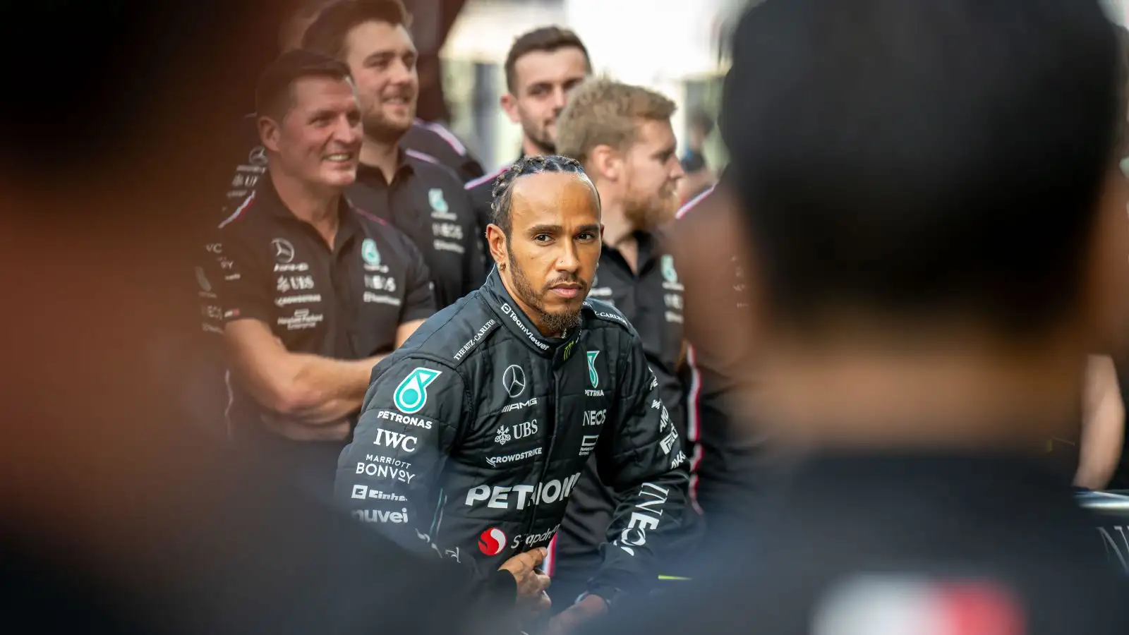Lewis Hamilton pictured among members of the Mercedes team.