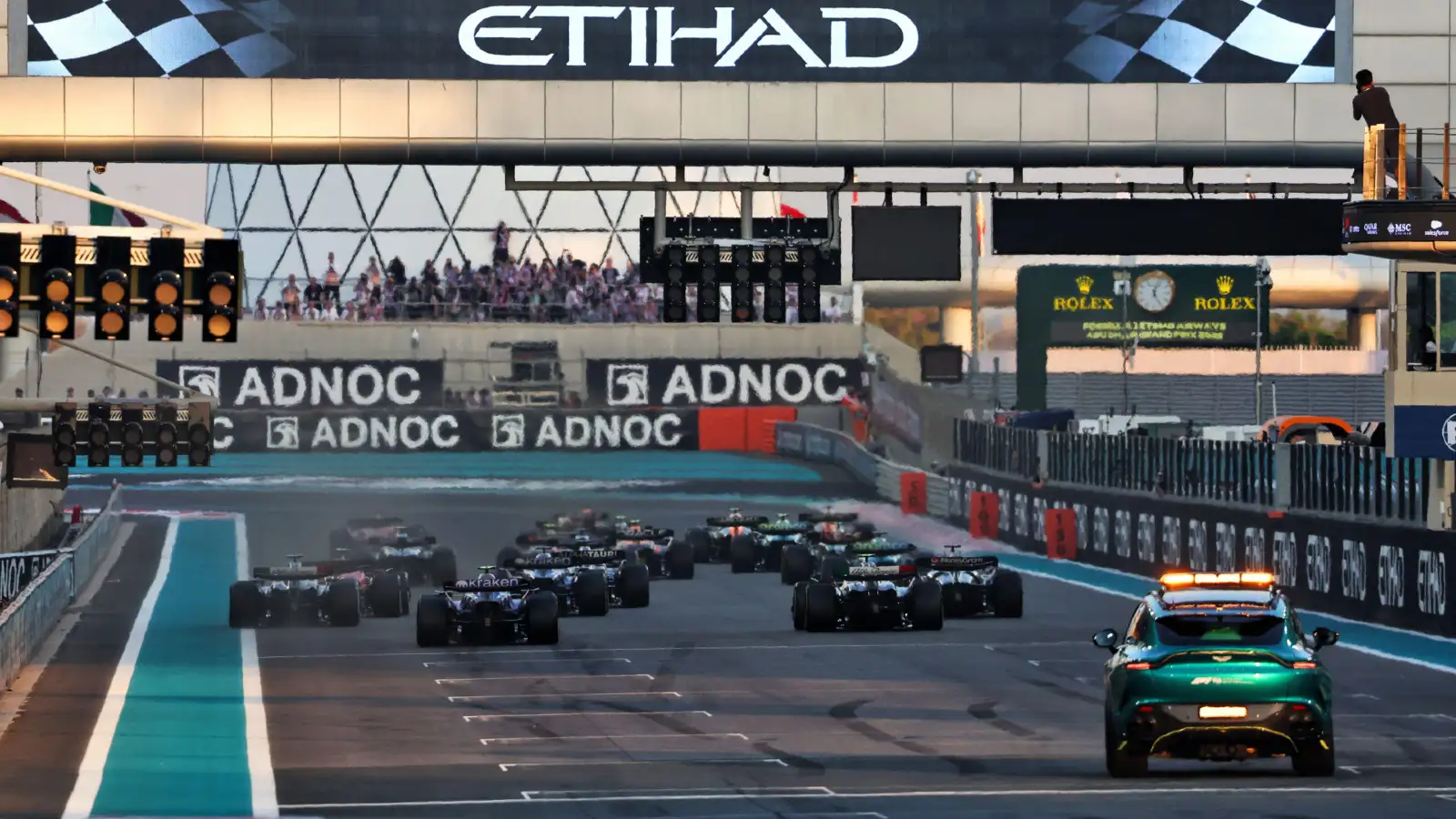 The F1 cars race into Turn 1 at the 2023 Abu Dhabi Grand Prix.