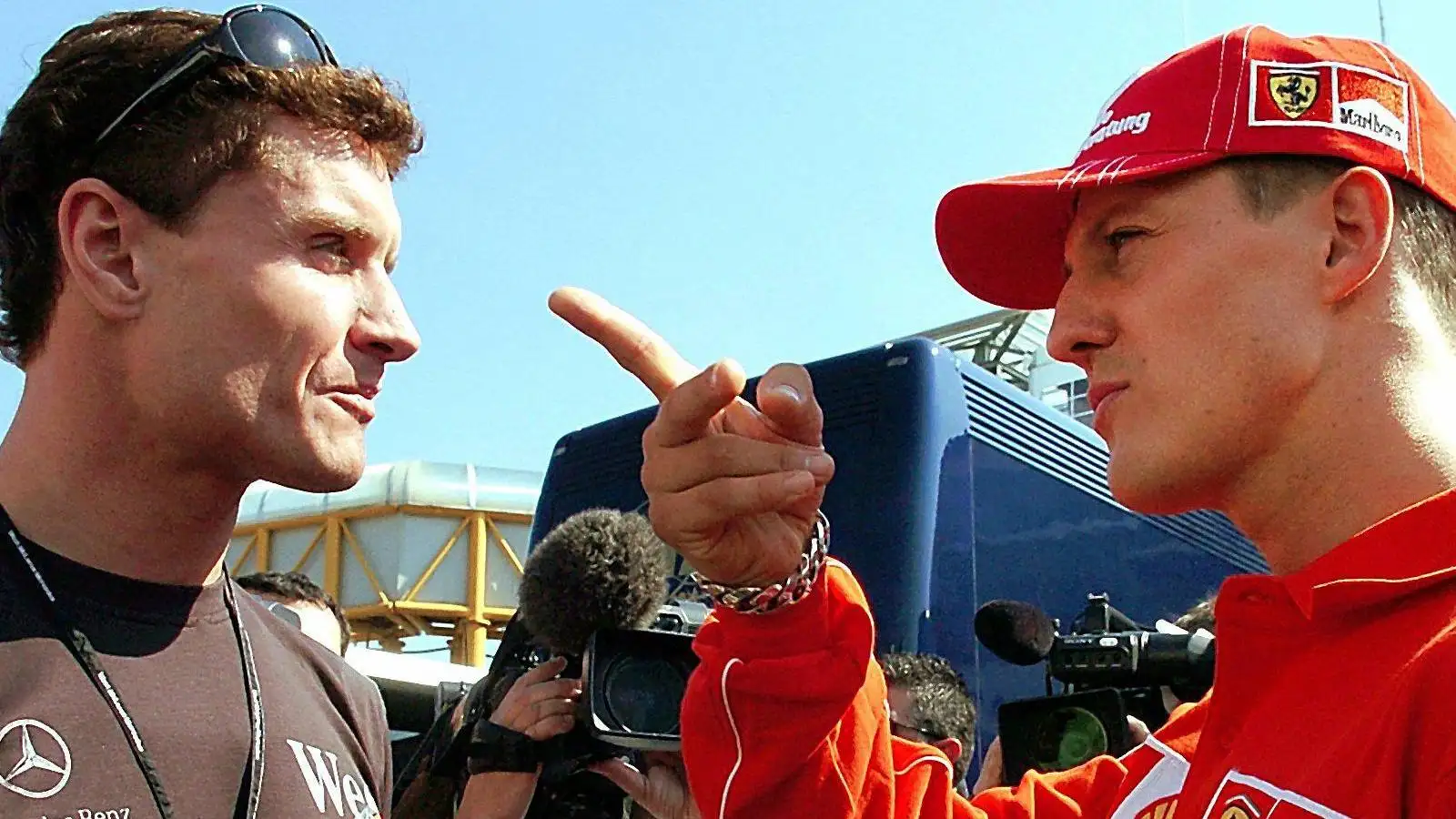 David Coulthard and Michael Schumacher in discussion at the 2004 San Marino Grand Prix.