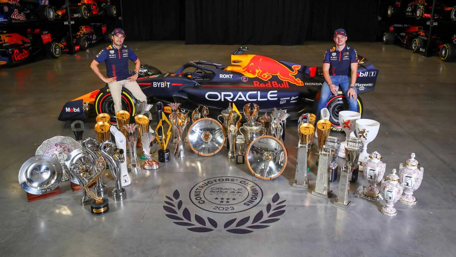 Red Bull drivers pose with their 2023 trophies.
