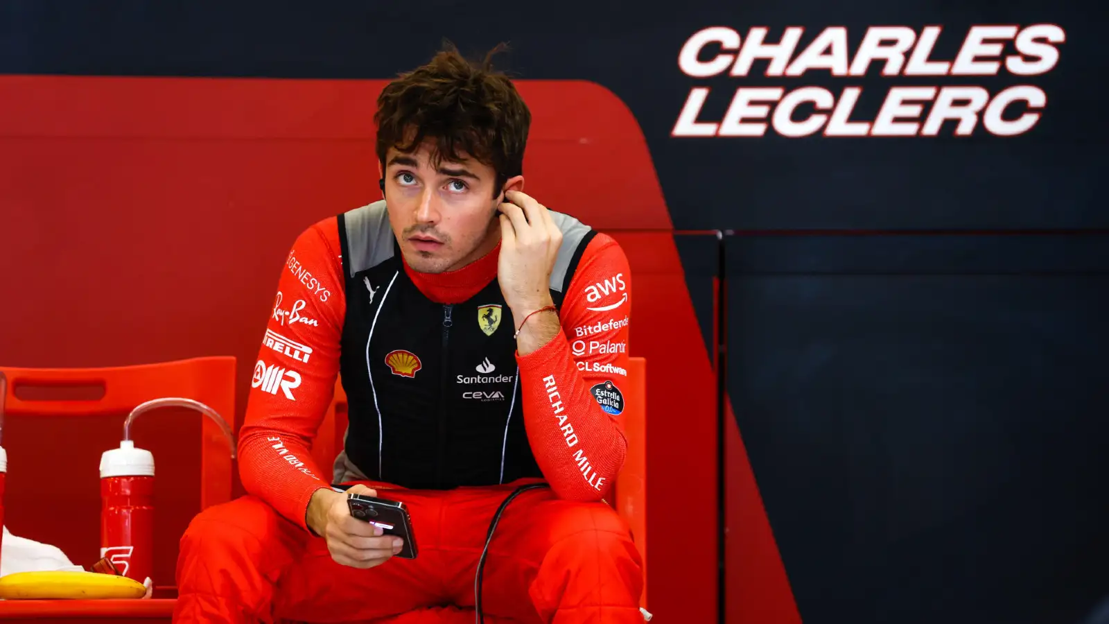 Charles Leclerc looks on in the Ferrari garage at the Abu Dhabi Grand Prix.