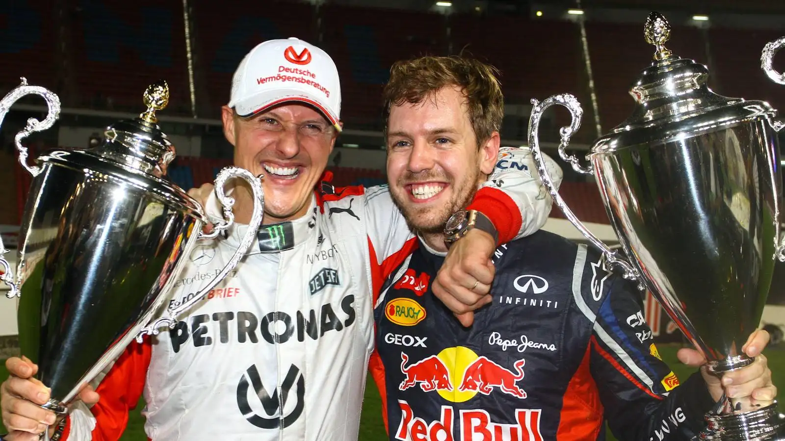 Michael Schumacher and Sebastian Vettel with Race of Champions trophies.