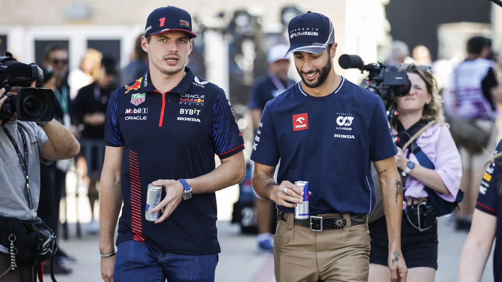 Max Verstappen and Daniel Ricciardo walk through the F1 paddock at the United States Grand Prix.