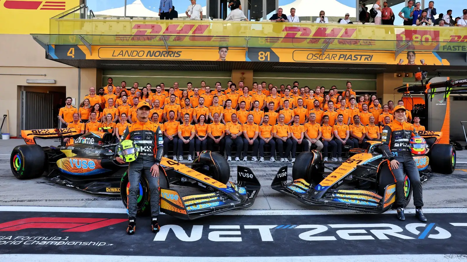 Lando Norris and Oscar Piastri pose with the McLaren team.