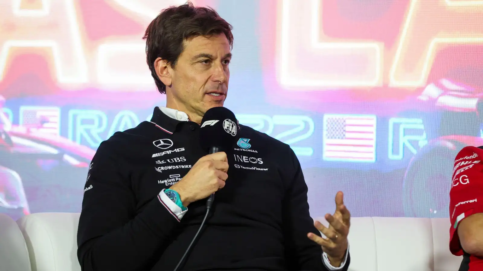 Toto Wolff speaks into a microphone.