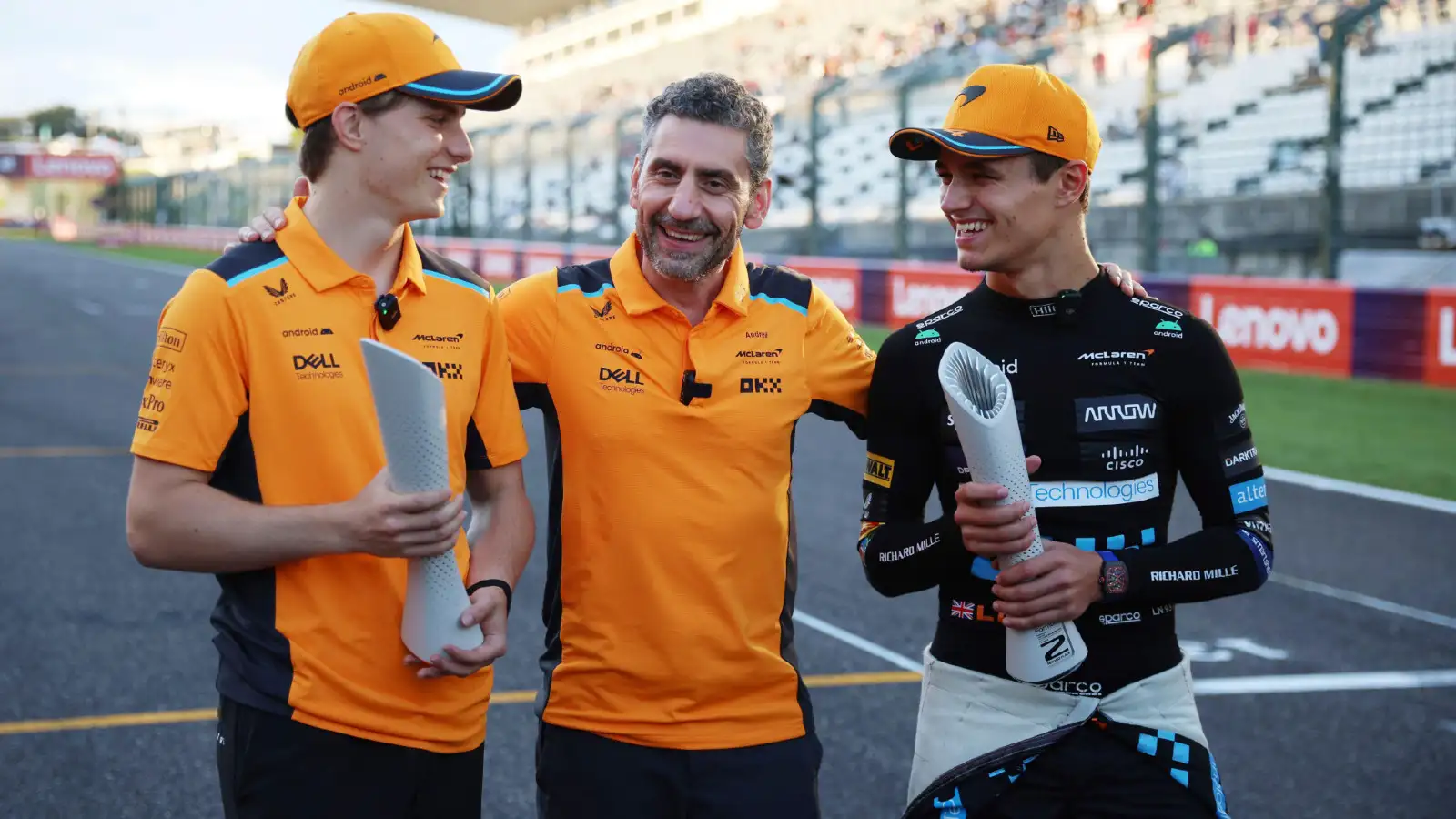 Oscar Piastri, Andrea Stella, and Lando Norris celebrate after the 2023 Japanese Grand Prix.