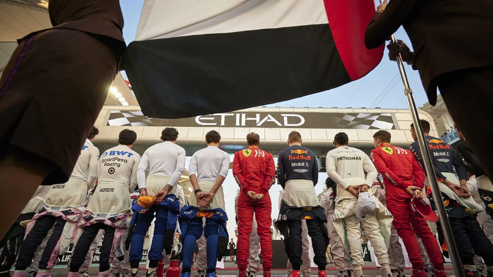 F1 drivers line up for national anthem.