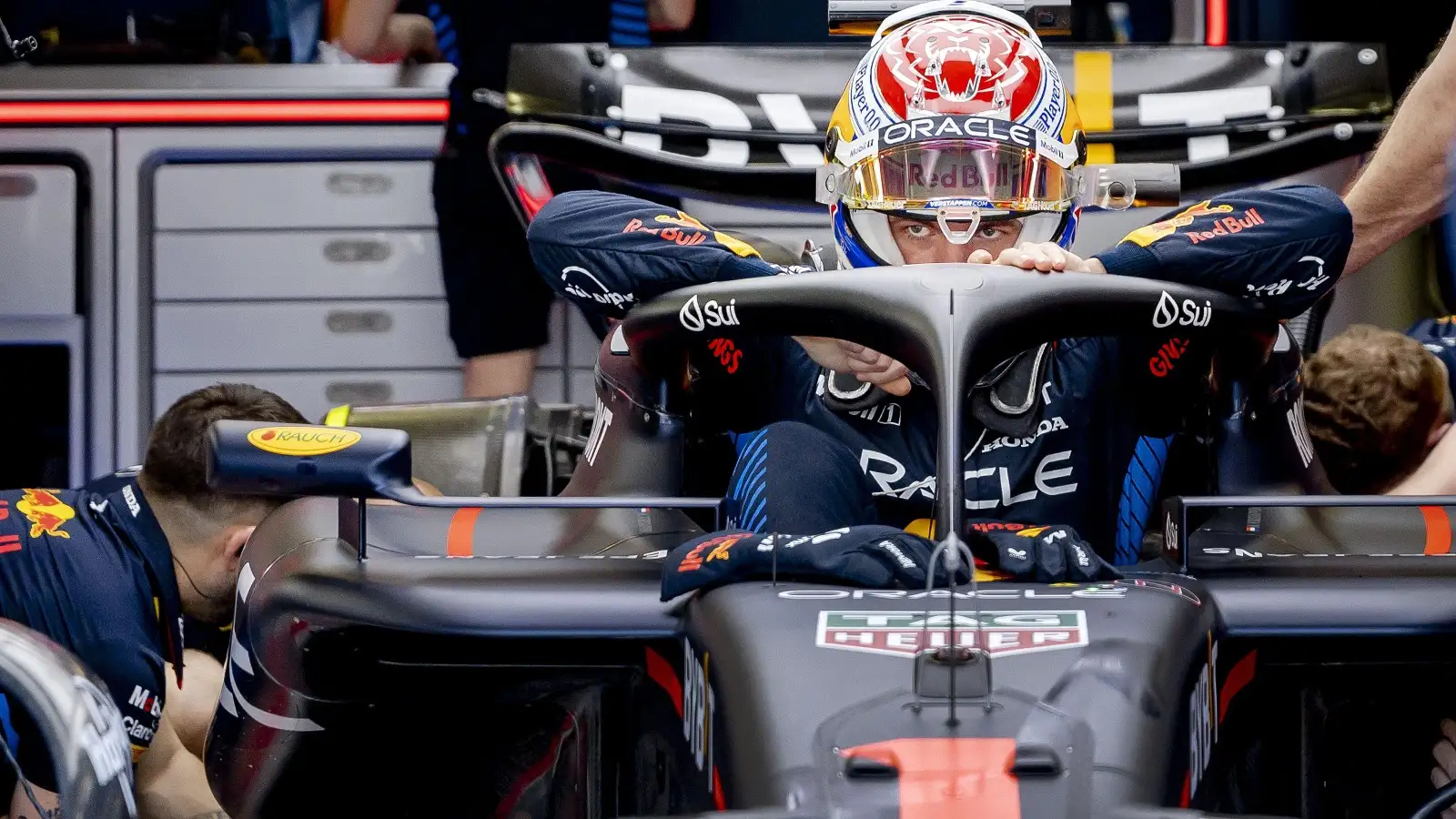 Max Verstappen climbs into the RB20.