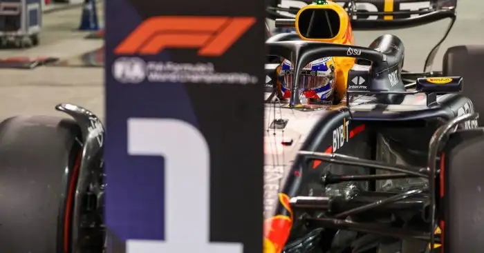 Max Verstappen parks in front of the No1 board