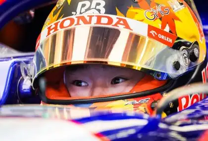 Yuki Tsunoda with his visor open in the cockpit of his RB F1 car