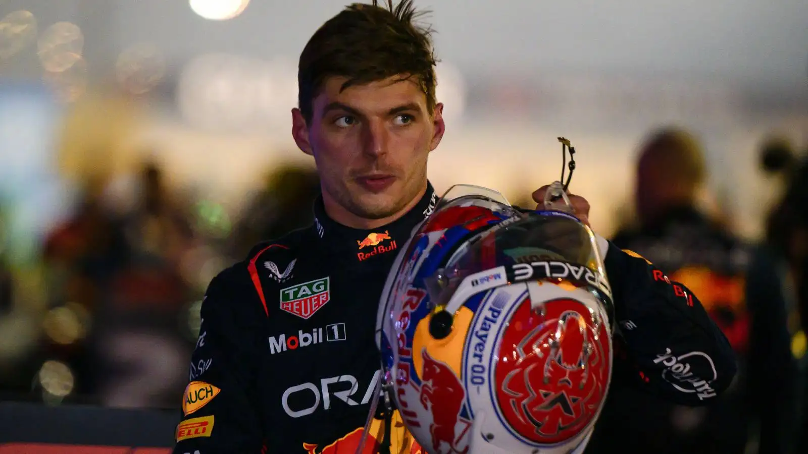 Red Bull driver Max Verstappen holding his helmet after winning the Bahrain Grand Prix.