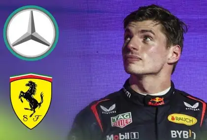 Max Verstappen looks to his right during the Saudi Arabian Grand Prix podium ceremony with prominent logos of Mercedes and Ferrari beside him