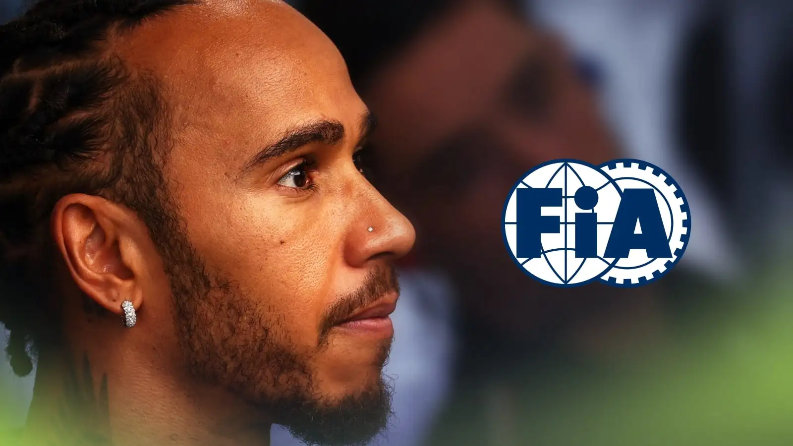 Lewis Hamilton looks concerned with a prominent FIA logo alongside him