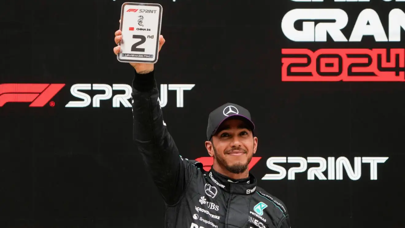 Lewis Hamilton holds aloft his P2 award in China