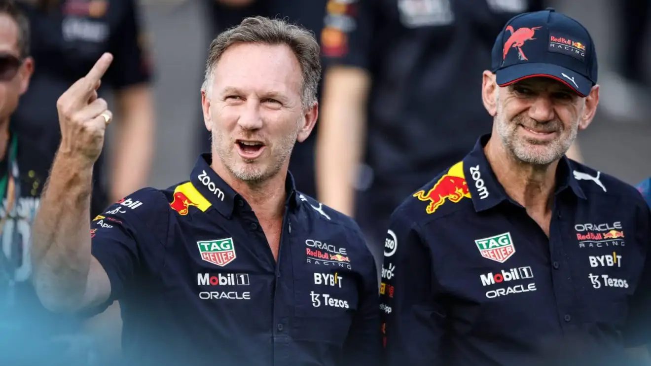 Christian Horner waves his middle finger as Adrian Newey laughs in the background