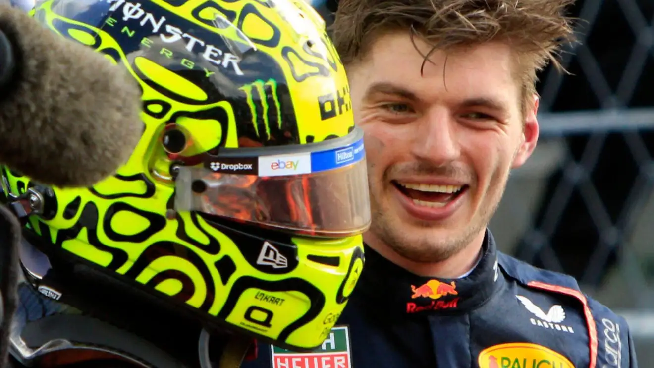 Max Verstappen smiling at Lando Norris after the McLaren driver's win