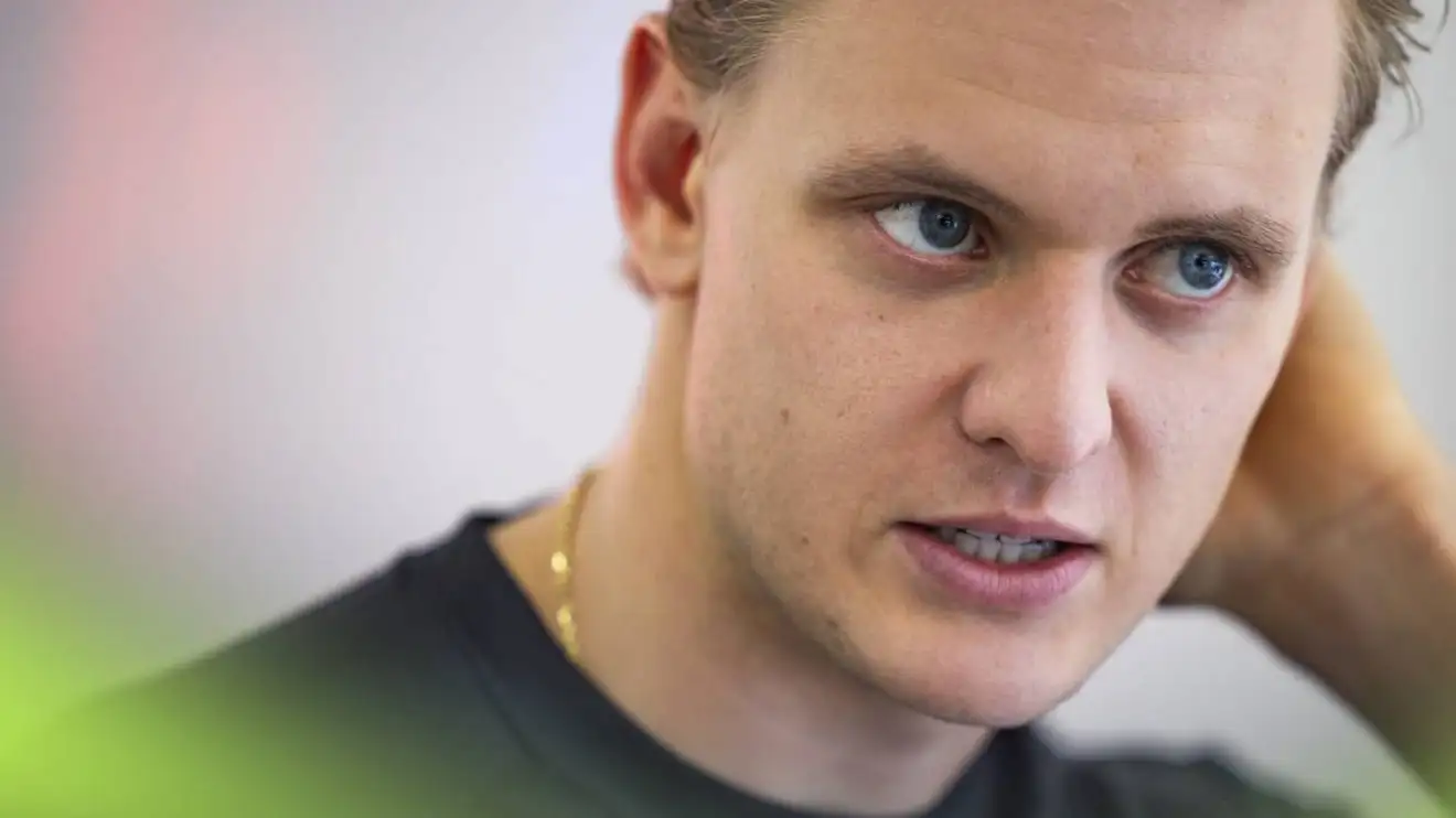 A portrait shot of a candid Mick Schumacher in conversation