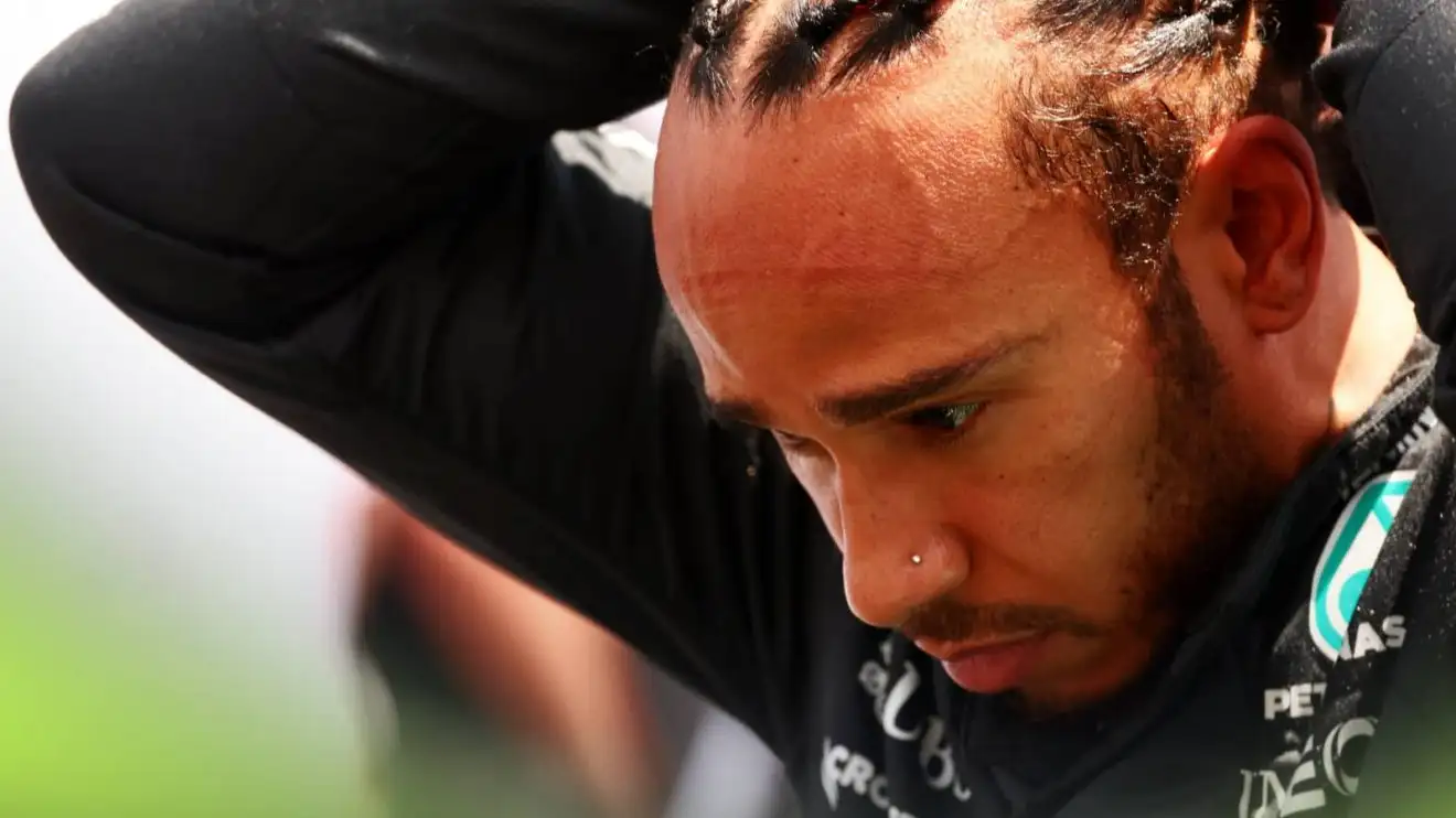 Lewis Hamilton looks down as he ties his hair on the grid at Miami