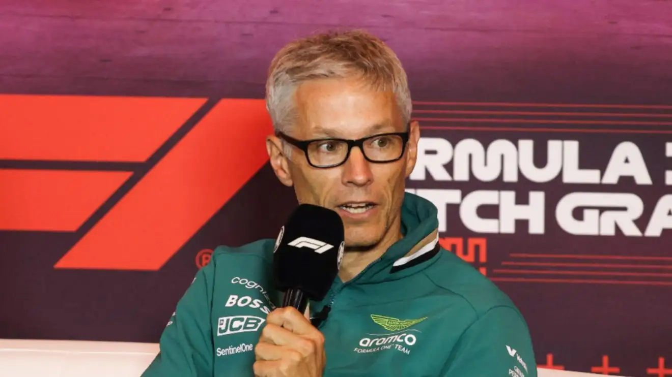 Aston Martin boss Mike Krack speaks into a microphone