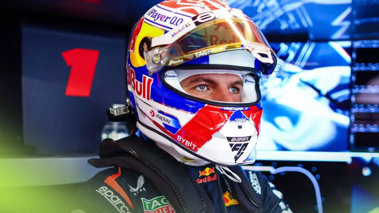 Max Verstappen has his visor open as he looks out from the back of the Red Bull garage at Monza