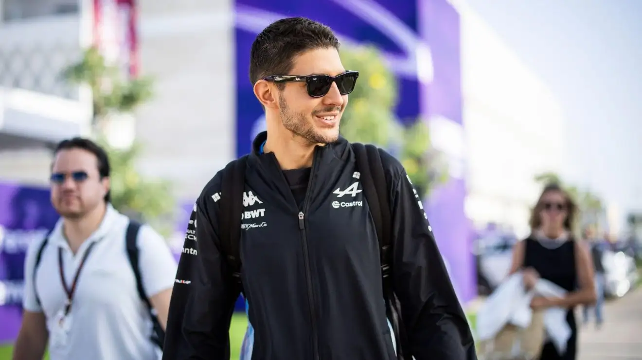 Esteban Ocon smiles with sunglasses on