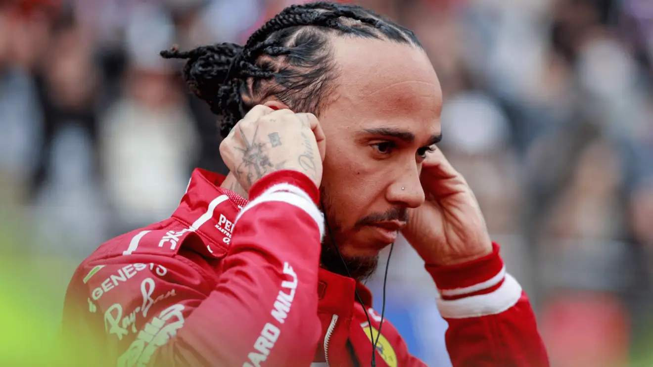 Lewis Hamilton inserts his earplugs on the grid in Shanghai