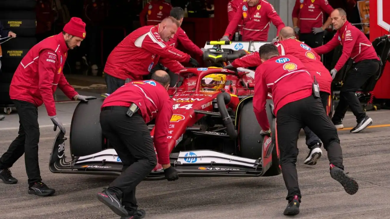 Lewis Hamilton in his Ferrari wheeled back to the garage by the crew at the 2025 Japanese Grand Prix