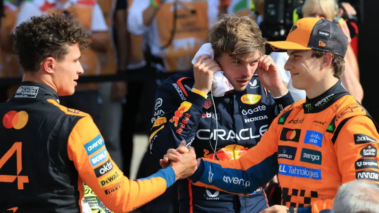 Lando Norris and Oscar Piastri shake hands with Max Verstappen standing behind themLando Norris and Oscar Piastri shake hands with Max Verstappen standing behind them