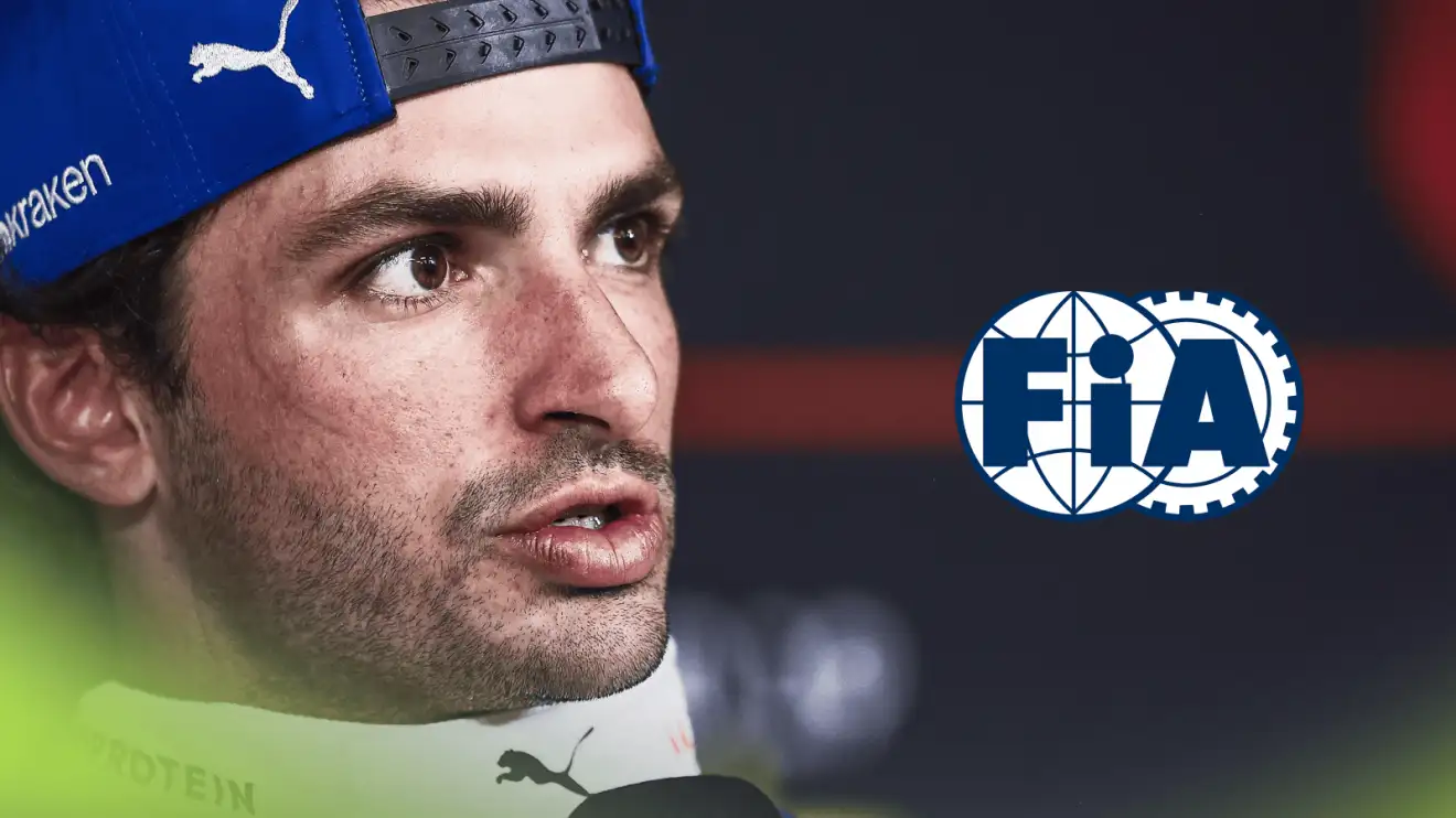 Carlos Sainz speaks in a press conference with a prominent FIA logo alongside him