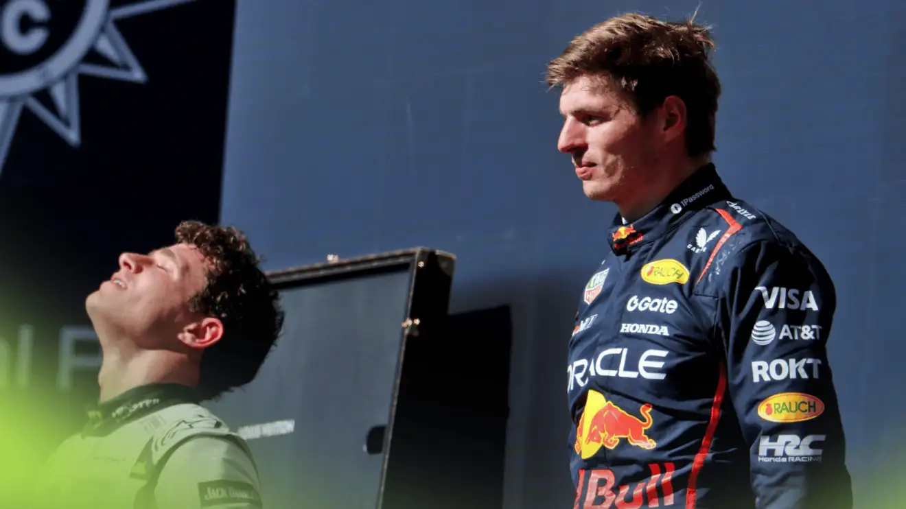 Lando Norris looks to the sky during the podium ceremony in Austin as Max Verstappen looks on
