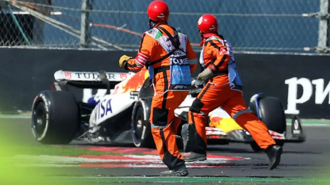 Liam Lawson, Racing Bulls, drives towards two marshals on the track at the 2025 Mexico City Grand Prix