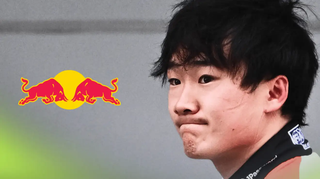 Yuki Tsunoda looks disappointed with a prominent Red Bull logo alongside him