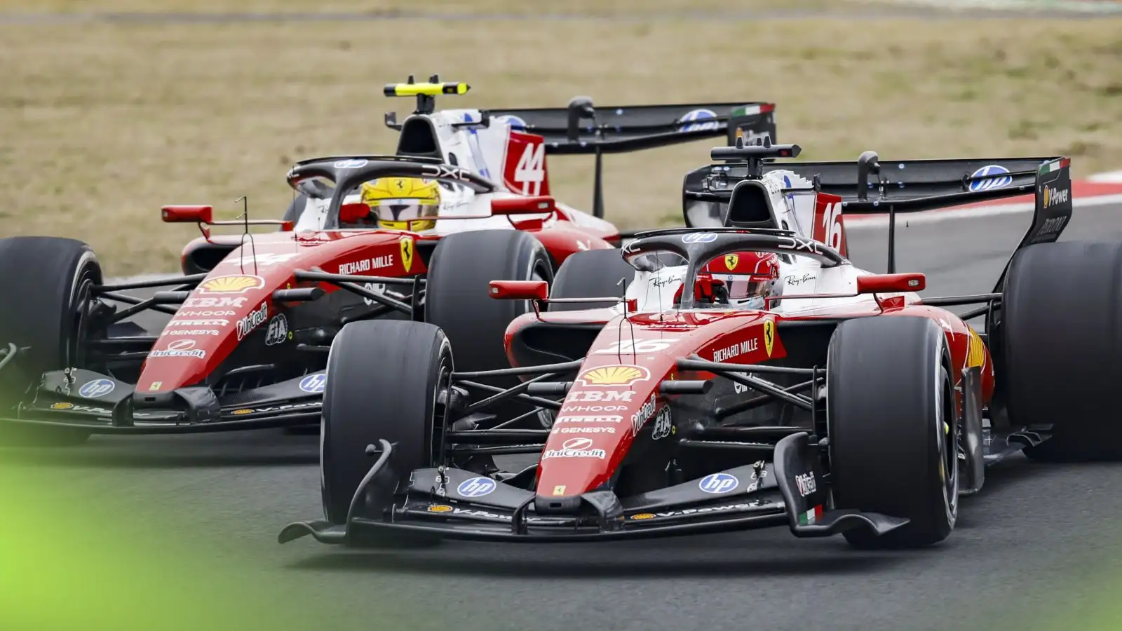 Lewis Hamilton and Charles Leclerc racing side by side in their Ferrari cars