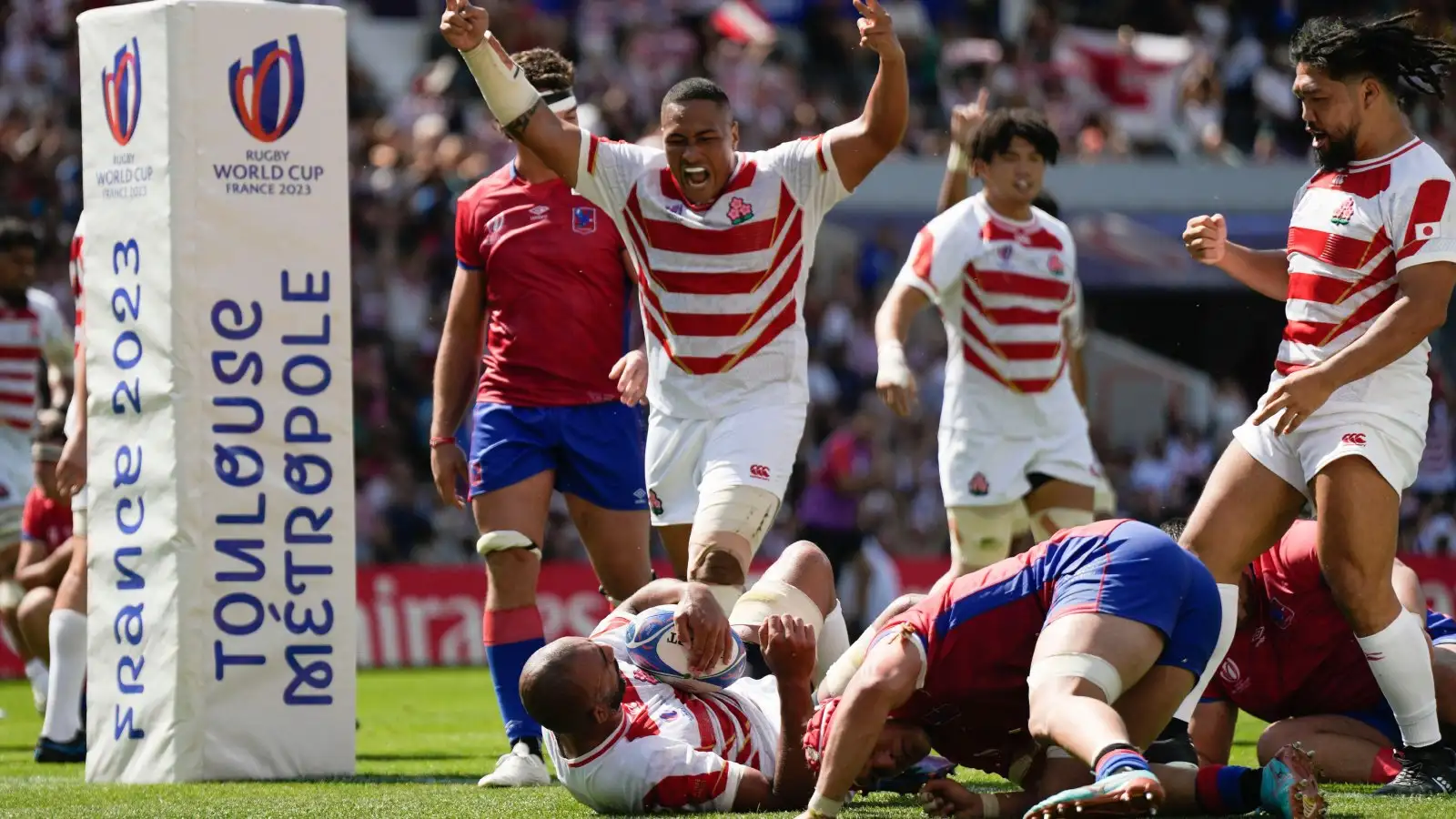 Japan players celebrate a try against Chile in the Rugby World Cup.