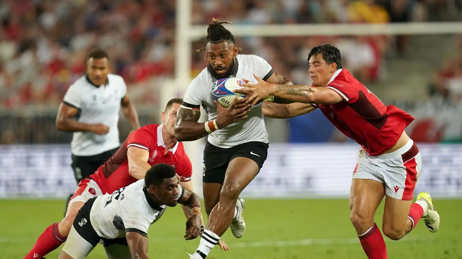Fiji's Waisea Nayacalevu is tackled by Wales' Louis Rees-Zammit (right) during the 2023 Rugby World Cup Pool C match at the Stade de Bordeaux, France.