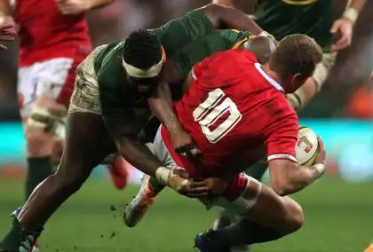 South Africa captain Siya Kolisi and Makazole Mapimpi of South Africa tackle Wales captain Dan Biggar during the 2022 Castle Lager Incoming Series match between South Africa and Wales held at Cape Town Stadium in Cape Town