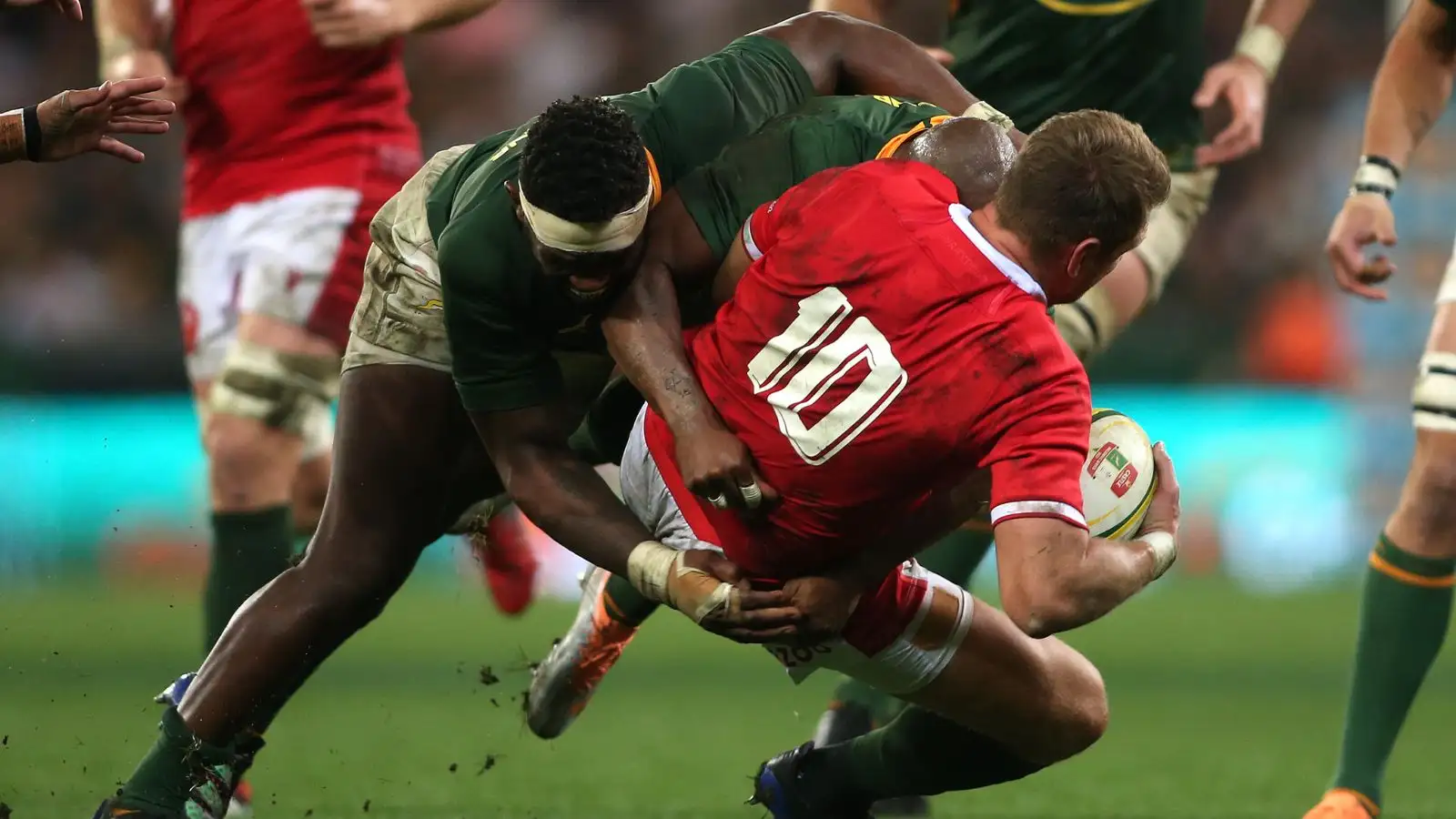 South Africa captain Siya Kolisi and Makazole Mapimpi of South Africa tackle Wales captain Dan Biggar during the 2022 Castle Lager Incoming Series match between South Africa and Wales held at Cape Town Stadium in Cape Town