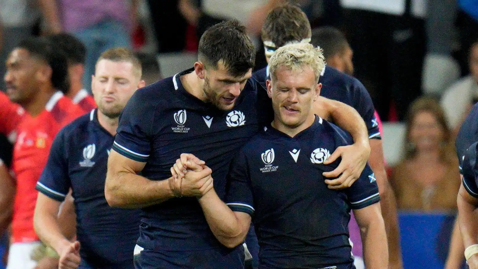 Scotland's Darcy Graham, right, celebrates with teammate Blair Kinghorn after marking a try during the Rugby World Cup Pool B match between Scotland and Tonga