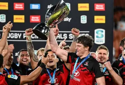 Crusaders captain Scott Barrett holds the trophy aloft as he celebrates with teammates after defeating the chiefs in the Super Rugby Pacific final in Hamilton, New Zealand, Saturday, June 24, 2023.