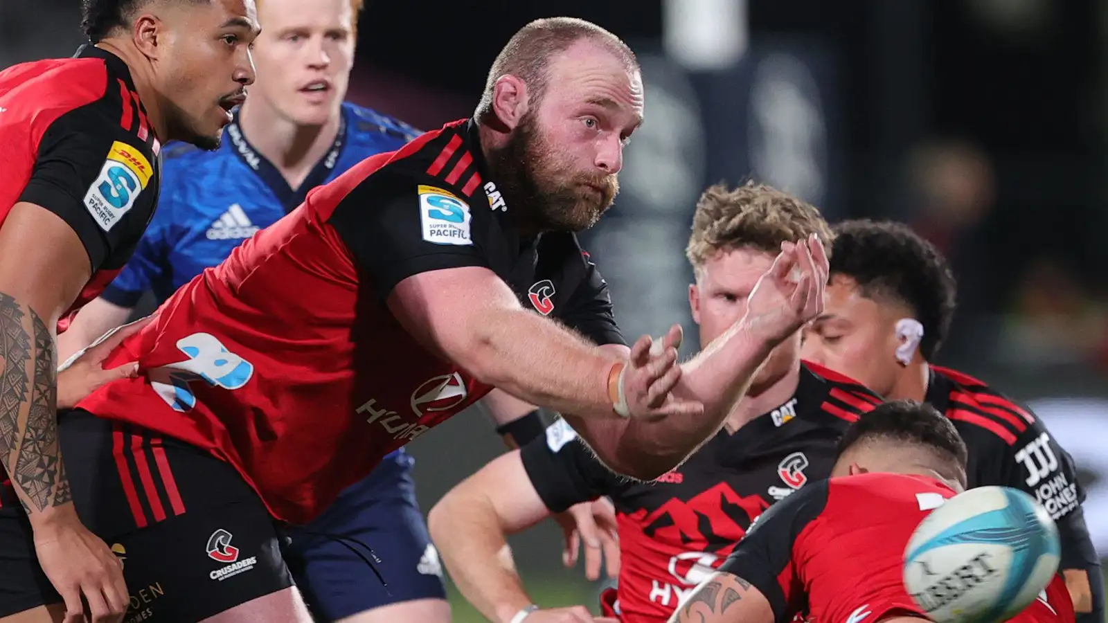 Crusaders prop Oli Jager passing in Super Rugby Pacific clash with the Blues.